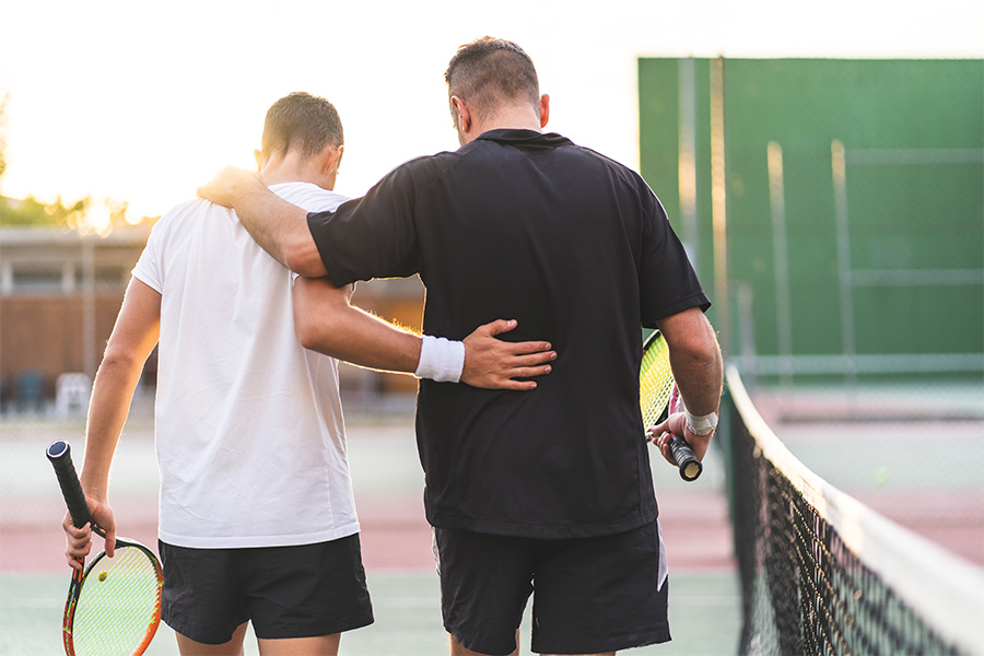 Tennis players embracing